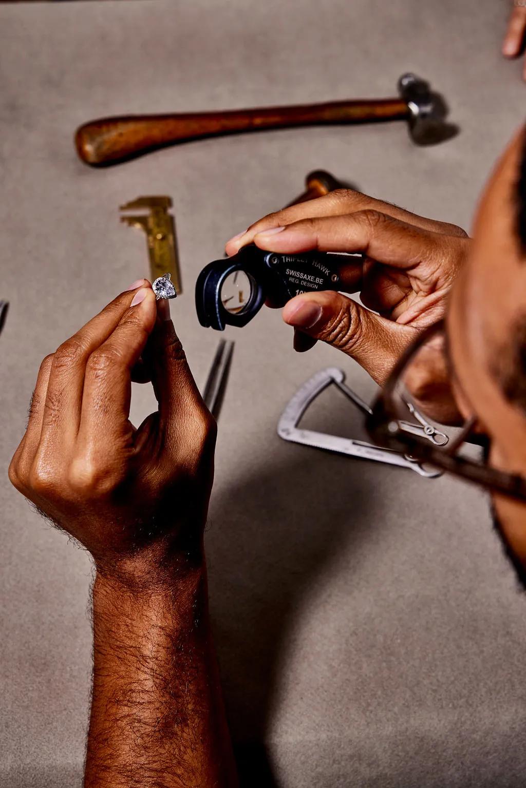 Designer examining a ring with a loupe
