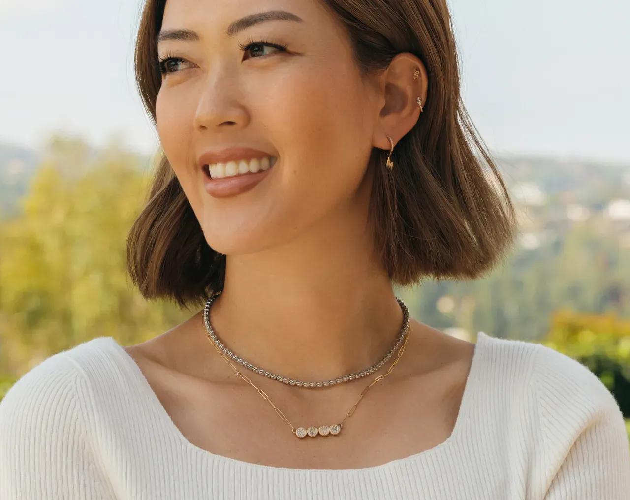 Michelle Wie West showing Wove's custom initial huggies earrings